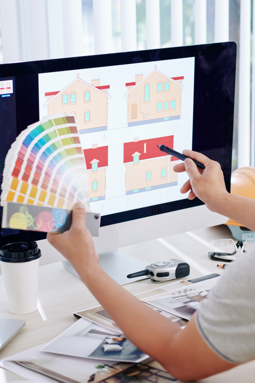 Interior designer checking colour swatches to match with computer image of home exterior